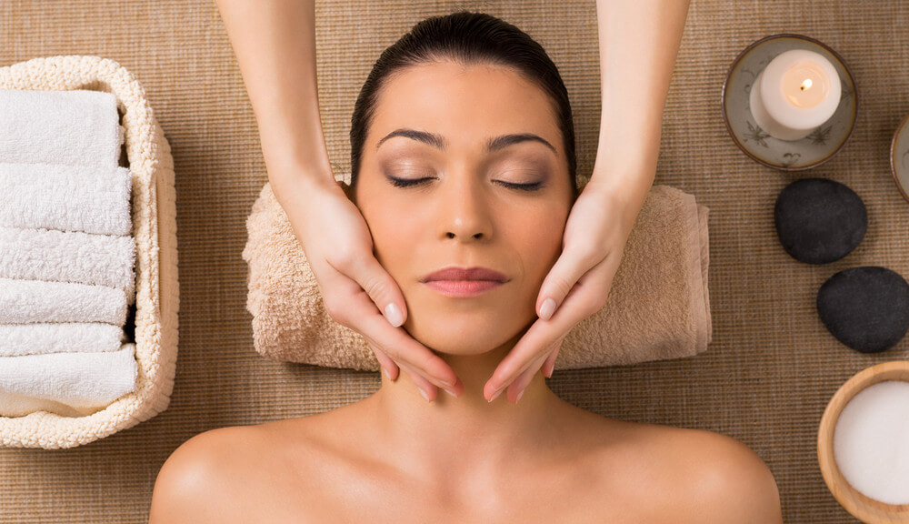 Woman getting facial at spa