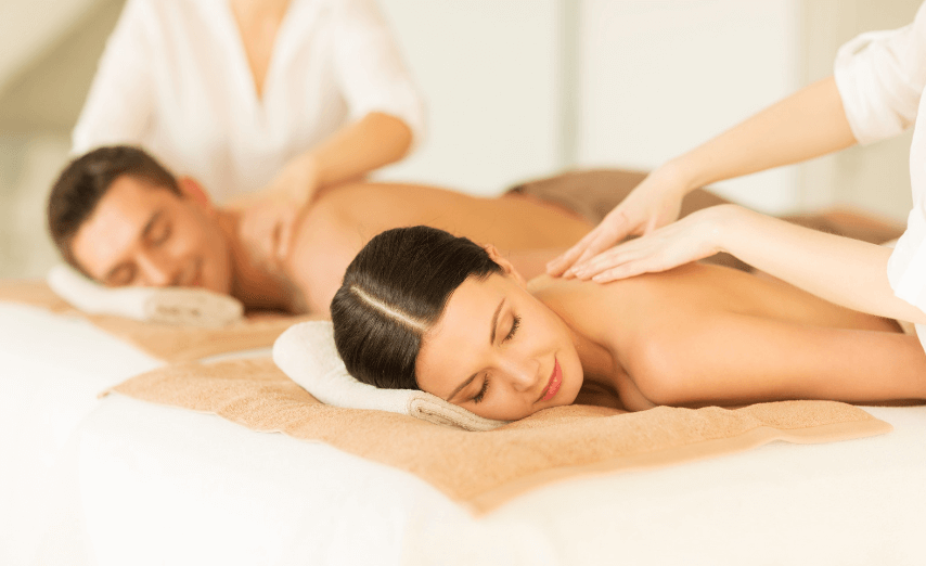 man and woman receiving couples massage