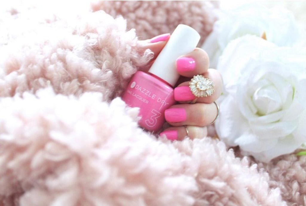 pink dazzle dry nail polish on beautifully manicured hands at colibri day spa sarasota