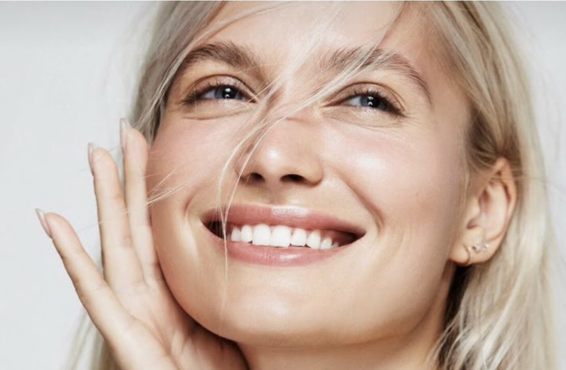 woman smiling after deep pore cleansing facial